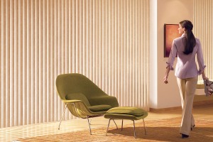Woman admiring tan vertical blinds